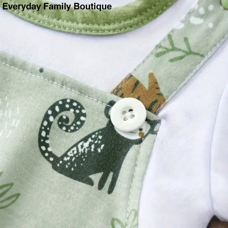 Black cat silhouette printed on mint green fabric with a white button fastener.