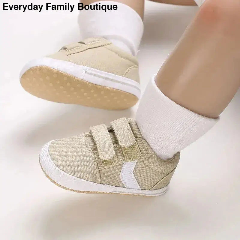 Beige and white velcro baby sneakers with white socks.