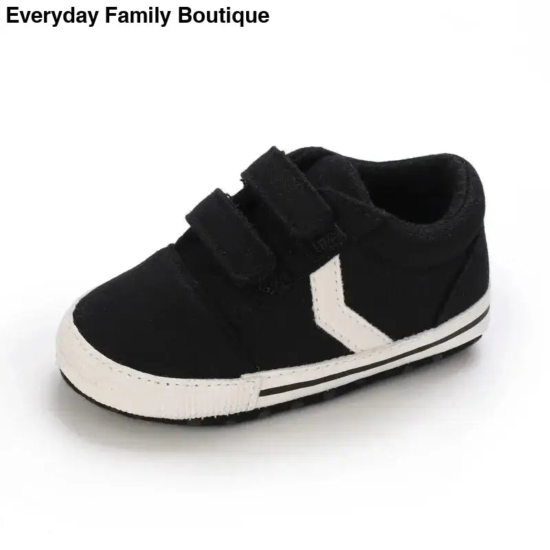 Black and white velcro sneaker with a side stripe design.