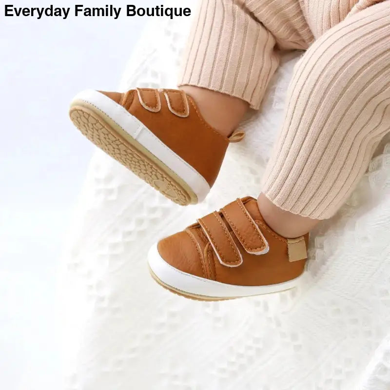 Brown leather velcro sneakers with white soles and ribbed cream socks.