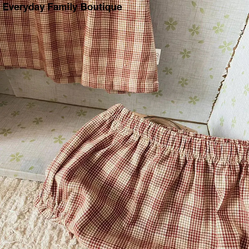 Red and white gingham fabric with gathered elastic edges.