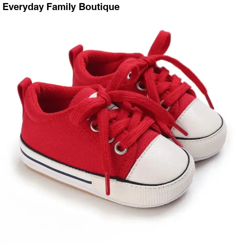 Pair of red canvas sneakers with white rubber toes and laces.