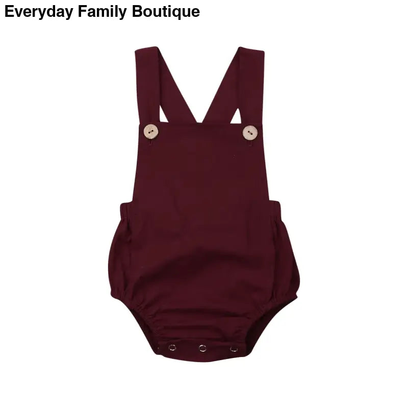 Burgundy cotton baby romper with shoulder straps and snap closures.