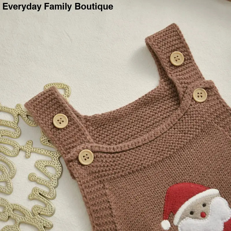 Brown knitted baby romper with wooden buttons and a Santa Claus applique.