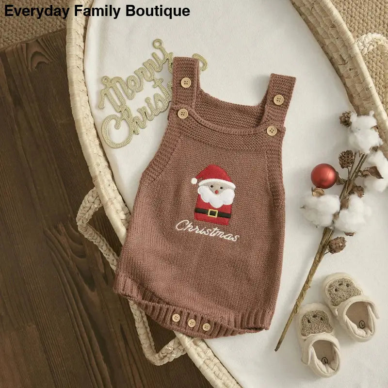 Brown knitted baby romper with a Santa Claus embroidery on the front.