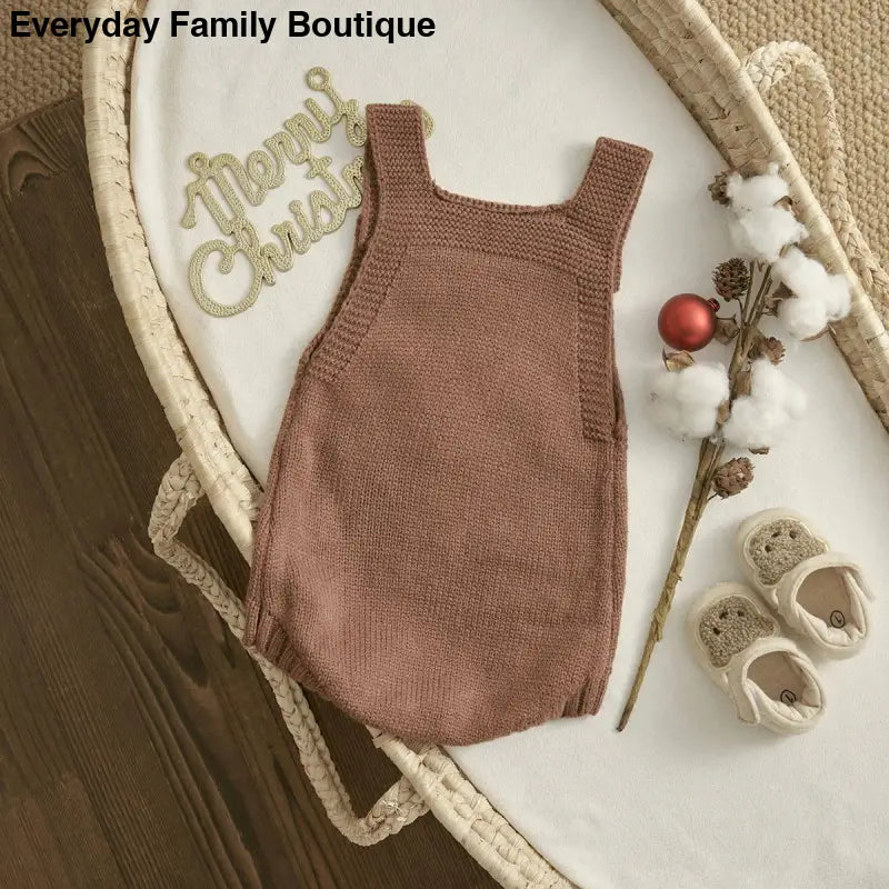 Knitted brown sleeveless baby romper.