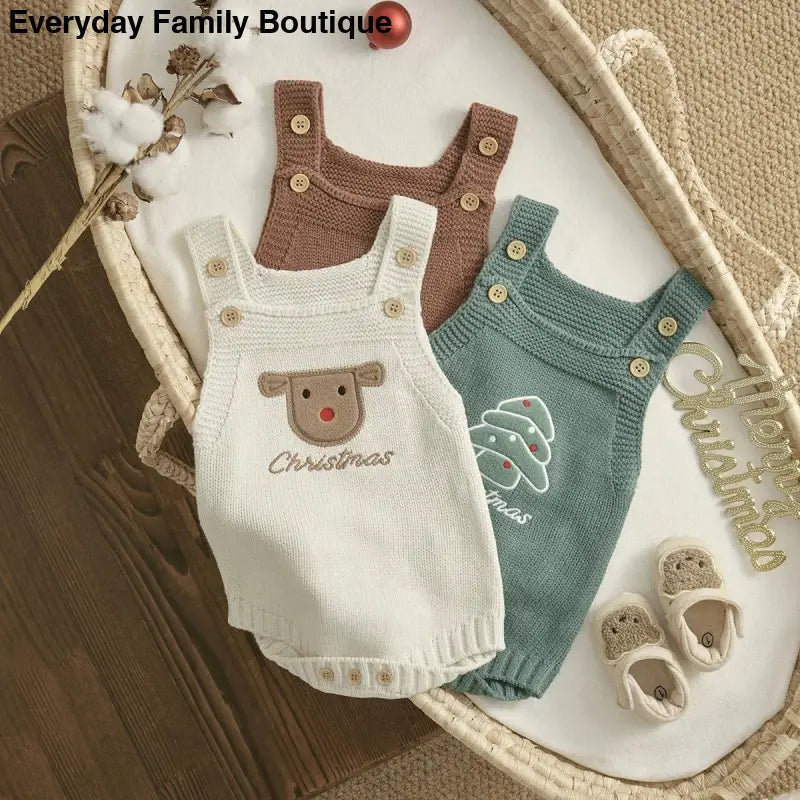 Three knitted baby rompers in brown, white, and teal colors with button straps.