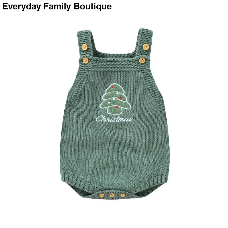 Green knitted baby romper with a Christmas tree design and button straps.