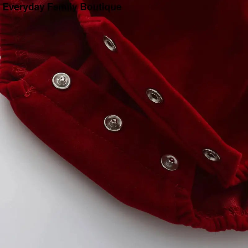 Red velvet fabric with silver snap buttons.