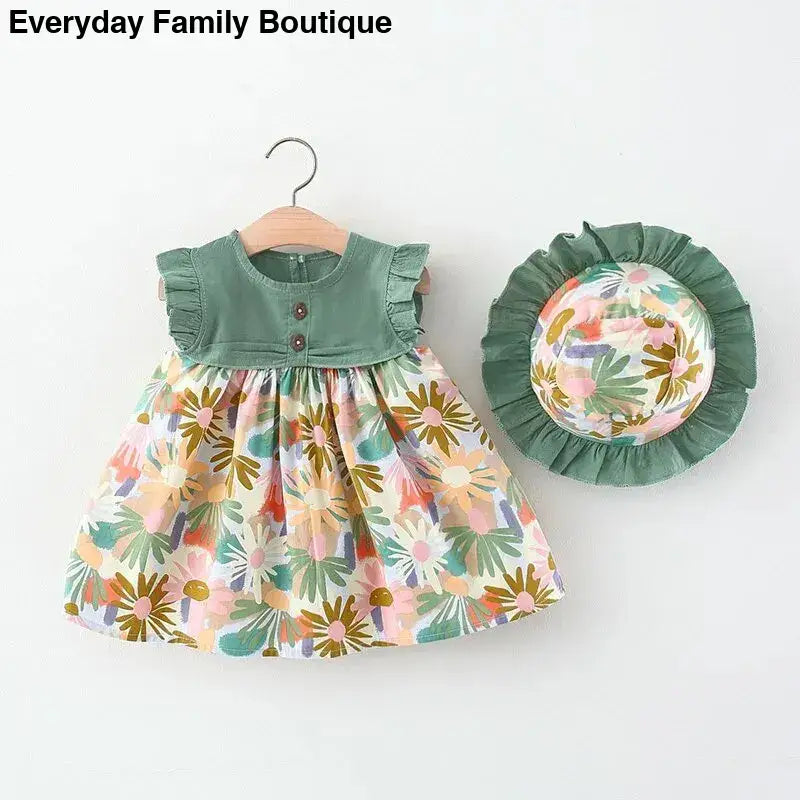 Sleeveless floral dress with green ruffled bodice and matching sun hat.