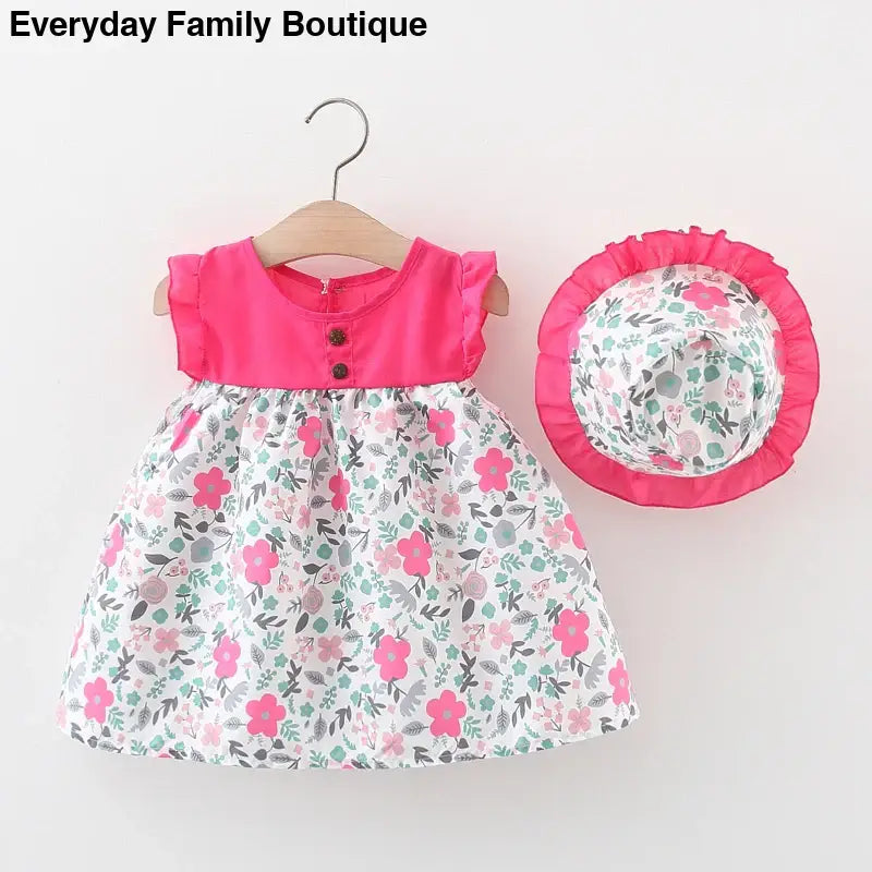 Pink and floral print baby dress with matching sun hat.