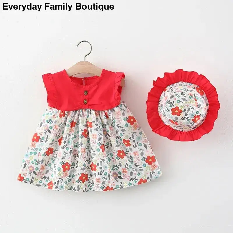 Red and white floral print baby dress with matching sun hat.