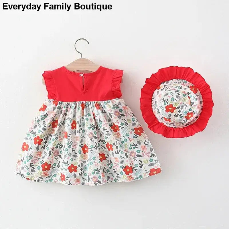 Red and white floral print baby dress with matching sun hat.