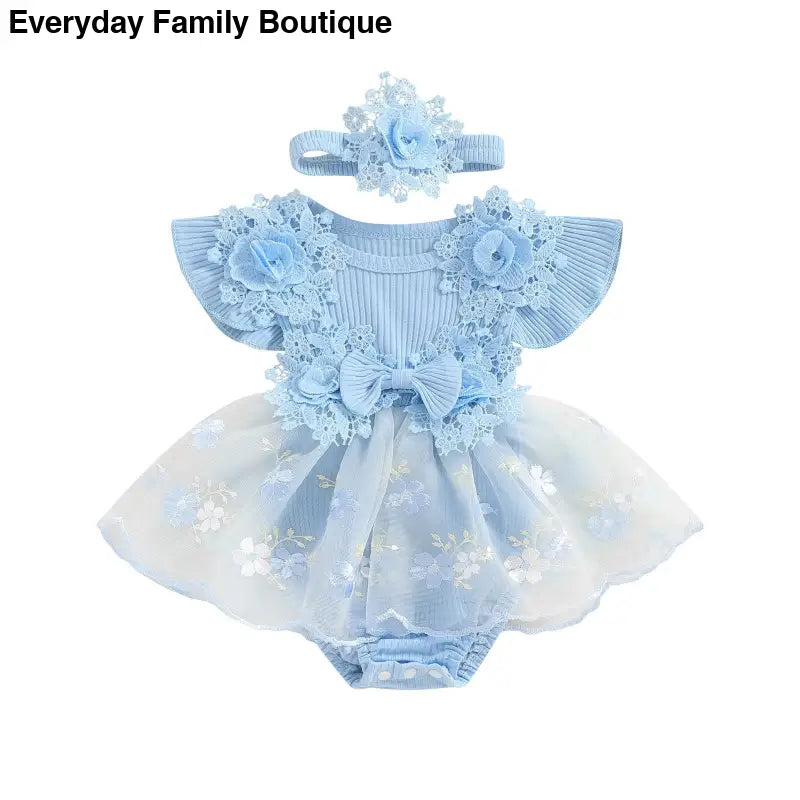 Light blue baby romper with tulle skirt, floral appliques, and matching headband.