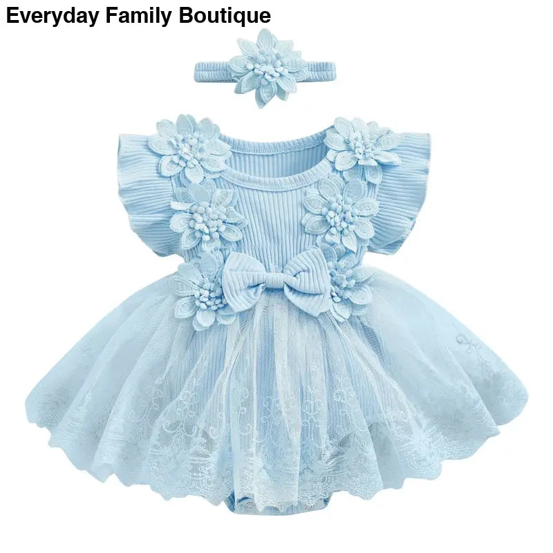 Light blue tulle dress with floral appliques and matching headband.