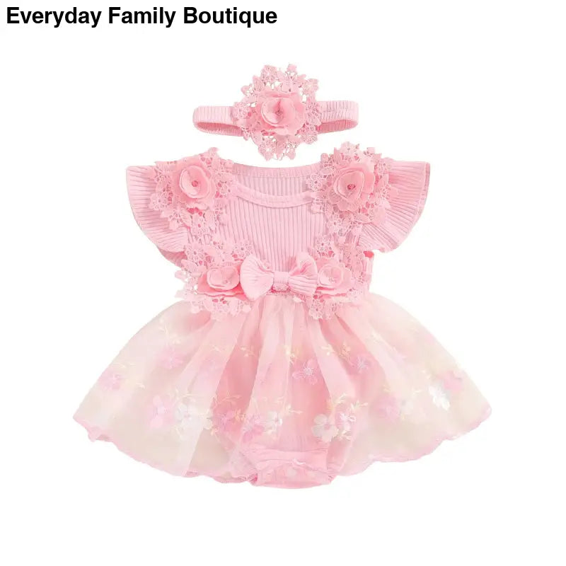 Pink frilly tulle dress with floral accents and matching headband.