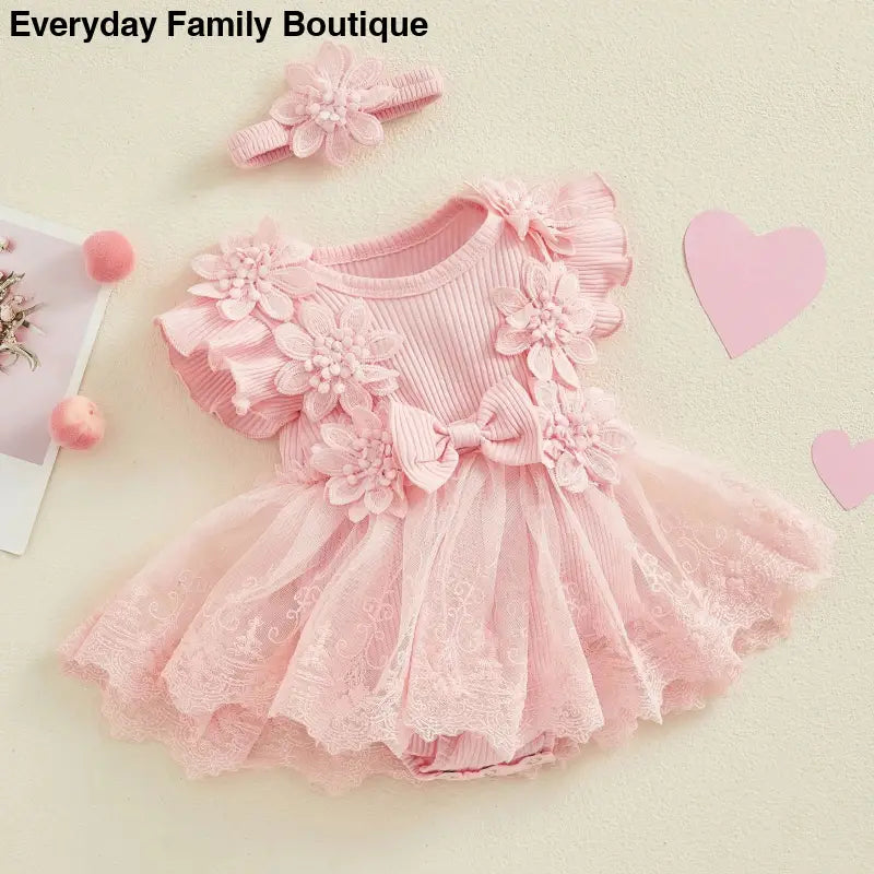 Pink tulle dress with floral appliques and matching headband.