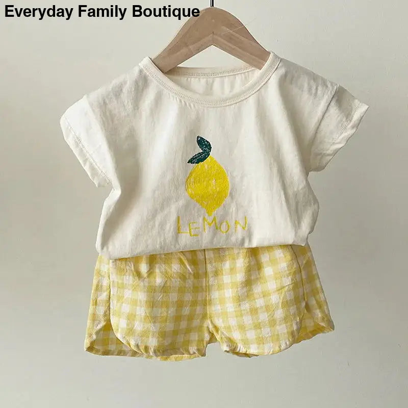 Children’s white t-shirt with lemon graphic and yellow gingham shorts set.