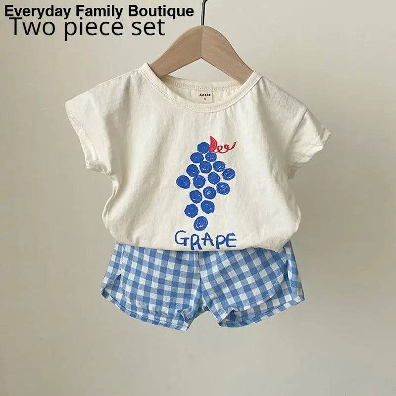 Children’s white t-shirt and blue gingham shorts set with a grape design.