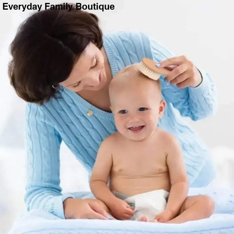 A baby getting their hair brushed while wearing a diaper.