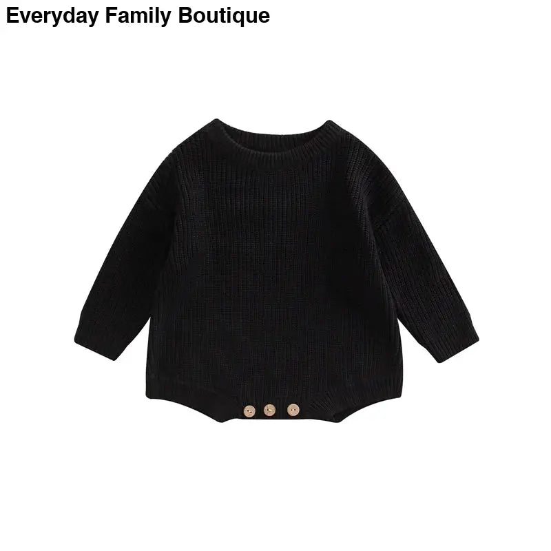 Black knitted sweater with three buttons at the bottom hem.