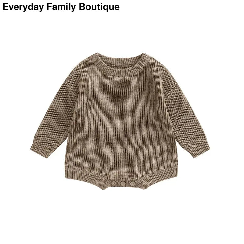 Brown knitted baby sweater with a waffle texture pattern.