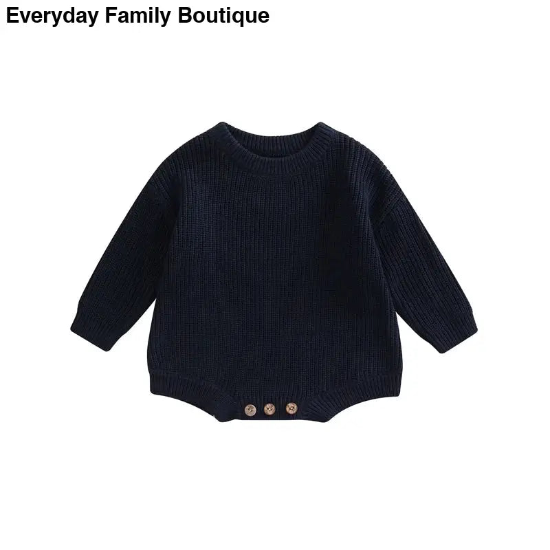 Navy blue knitted sweater with button details at the bottom.