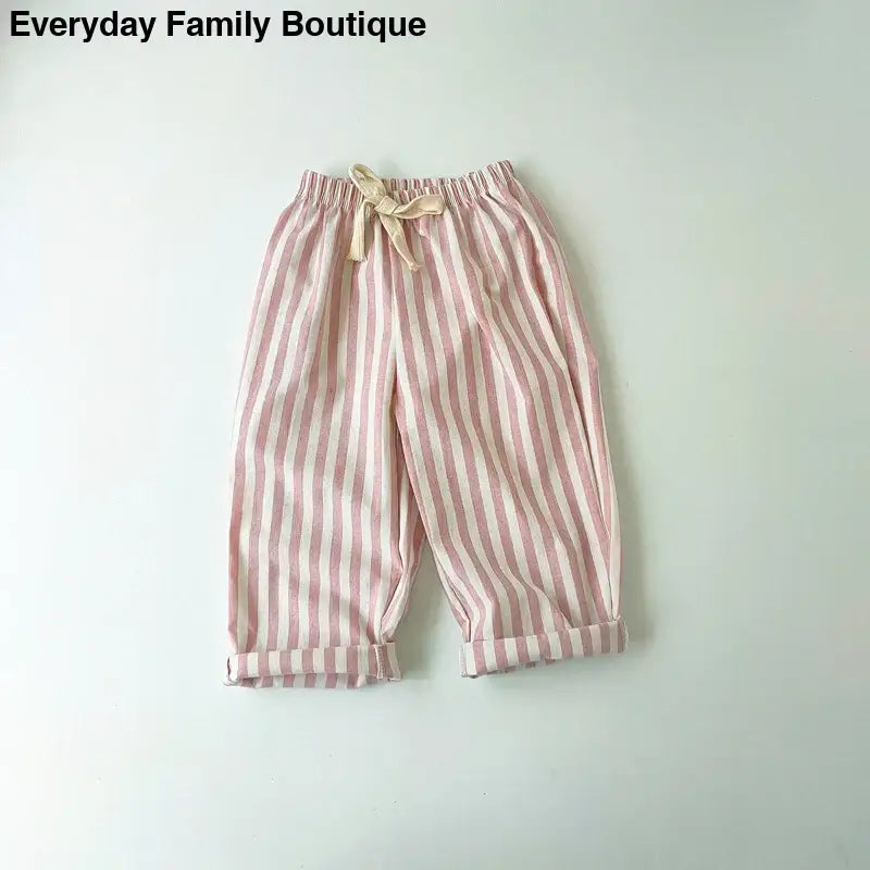 Pink and white striped cotton pants with an elastic drawstring waist.