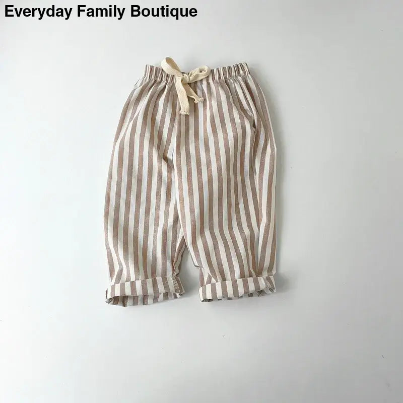 Striped beige and white cotton pants with an elastic waistband and drawstring.