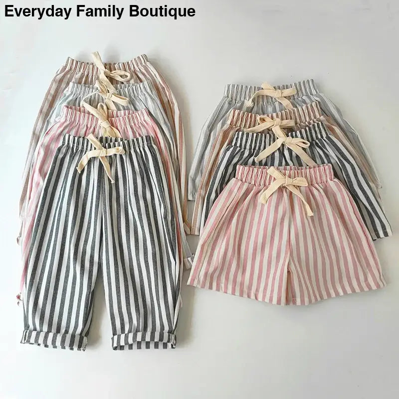 Striped cotton pants and shorts in pastel and neutral colors with drawstring waists.