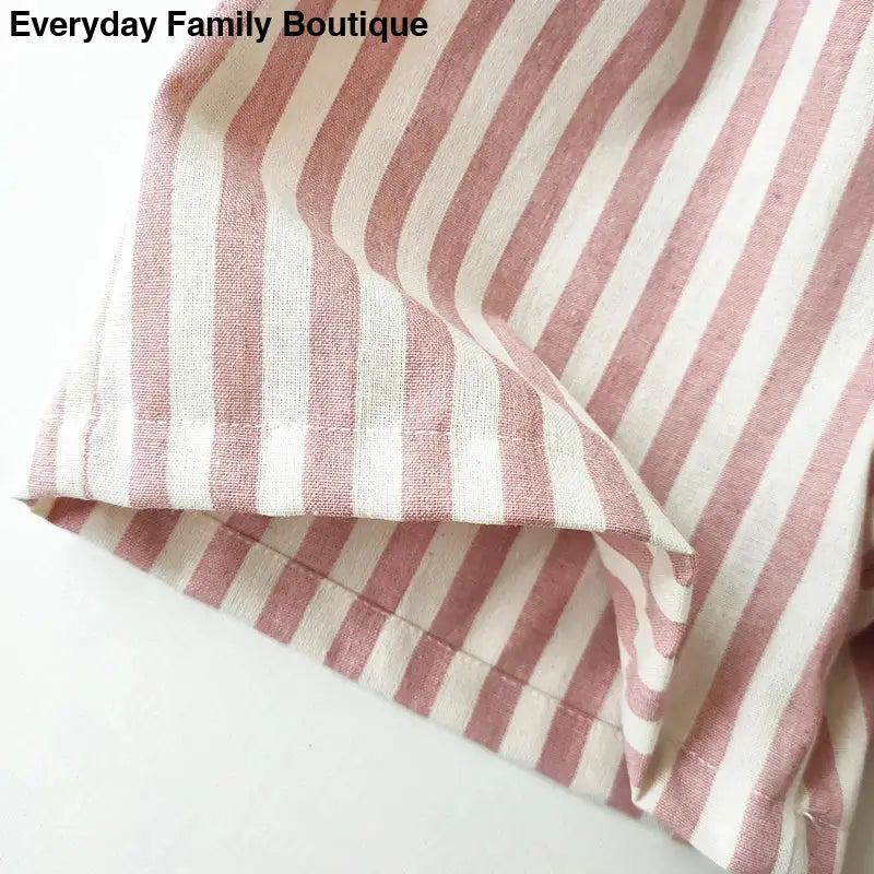 Pink and white striped fabric with folded edges.