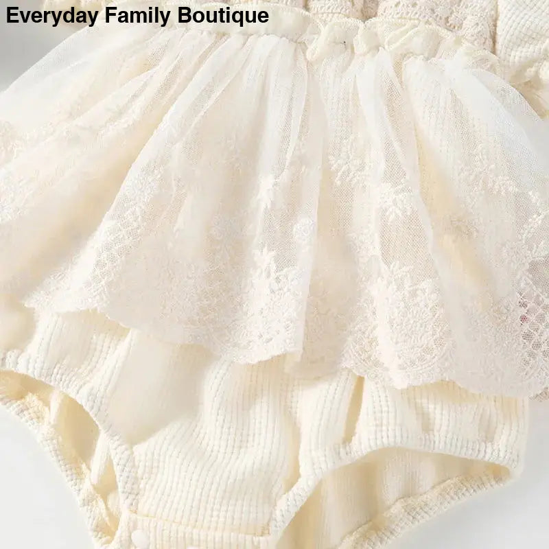 Delicate cream-colored lace bloomers with ruffled layers.