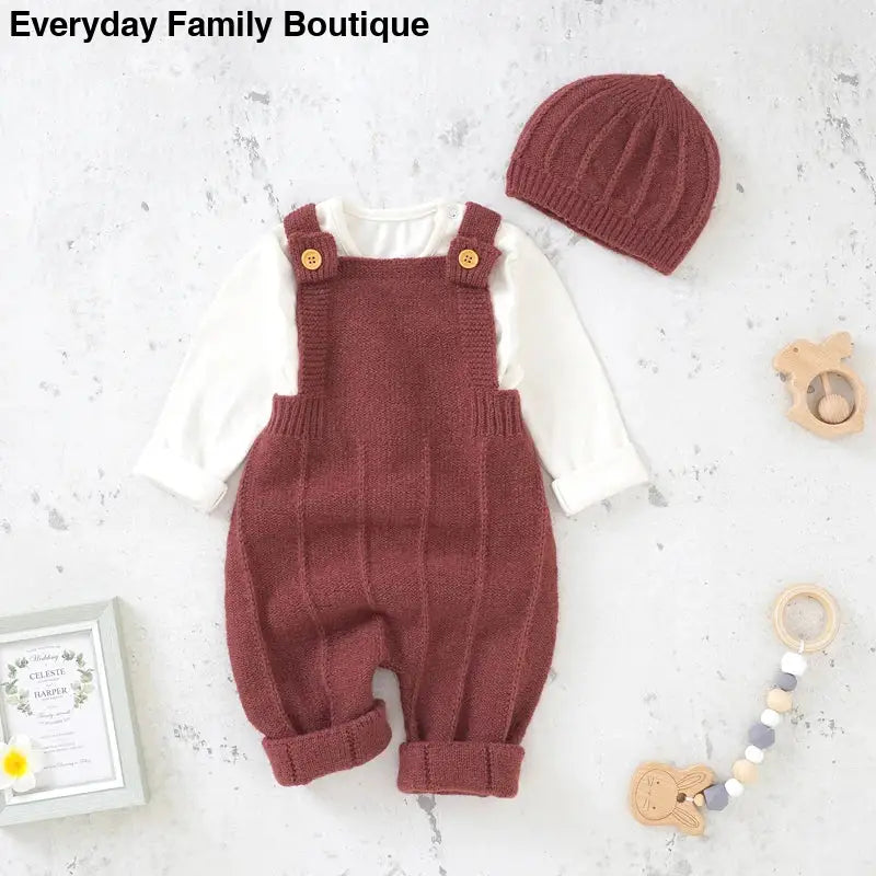 Burgundy knit baby overalls with matching beanie and white long-sleeve undershirt.