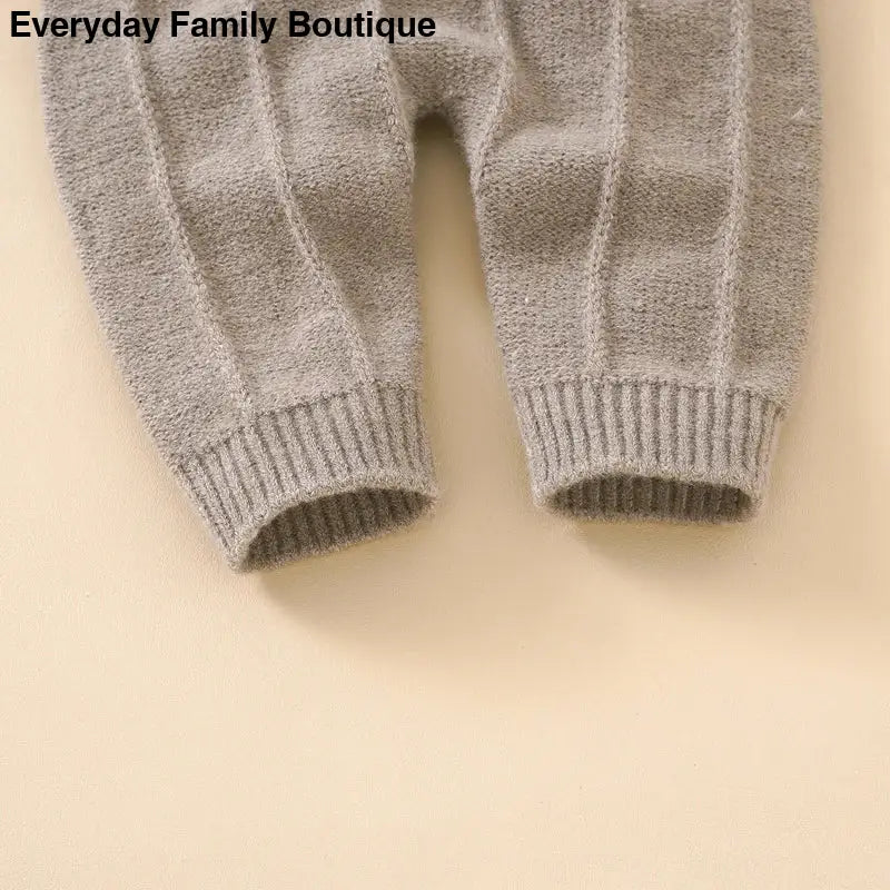 Gray knitted pants with ribbed cuffs.