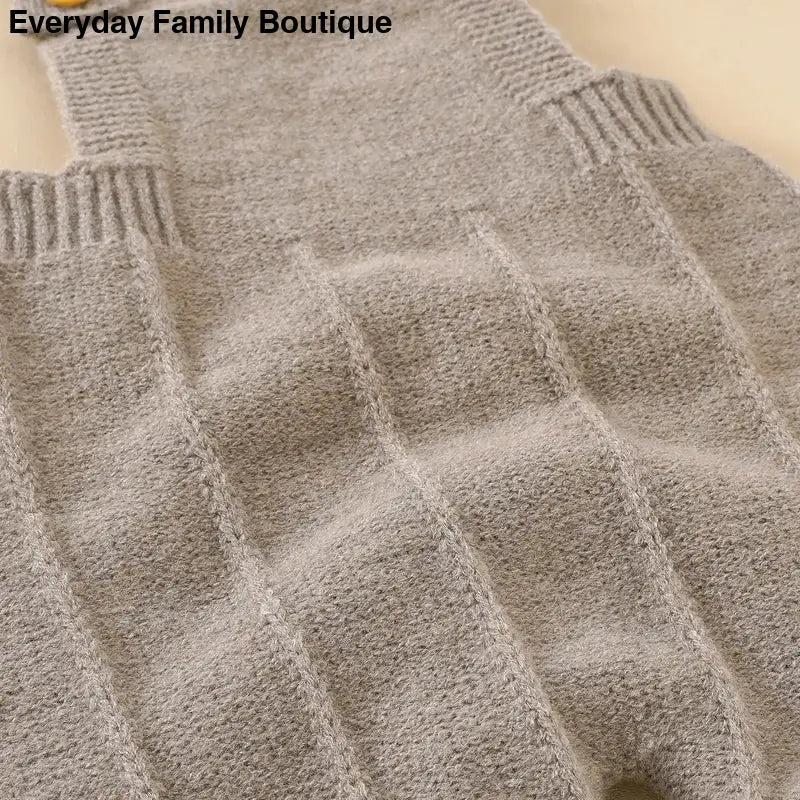 Gray knitted sweater with a diamond pattern texture.