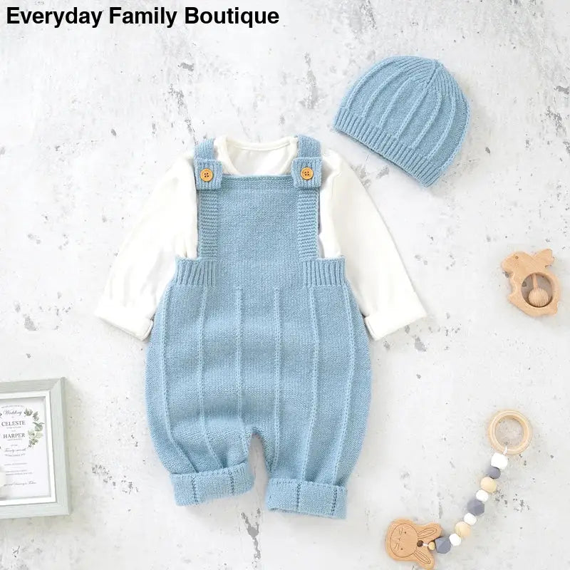 Light blue knitted baby overalls with white long sleeves.