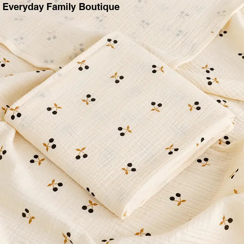 White fabric with a repeating pattern of small black dots and gold accents.