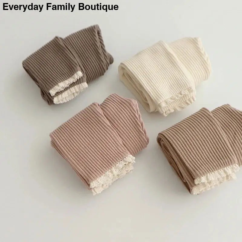 Ribbed fabric swatches with lace trim in brown, cream, pink and taupe colors.