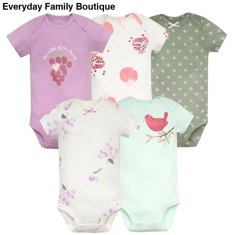 Collection of baby onesies in pastel colors with floral and bird designs.