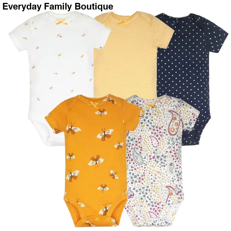 Five baby onesies in different patterns including polka dots, stripes, floral prints, and paisley designs.