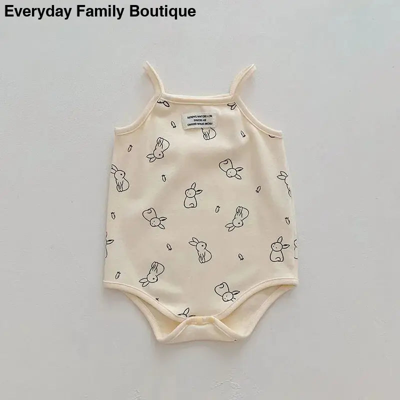 Cream-colored baby bodysuit with small bunny rabbit print pattern.