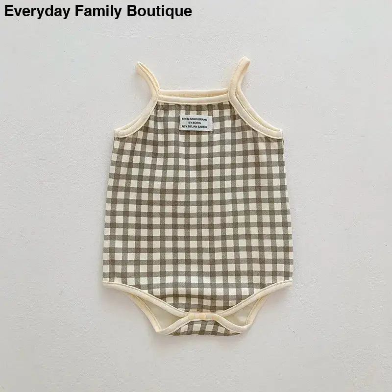 Sleeveless baby bodysuit with brown and white gingham check pattern.