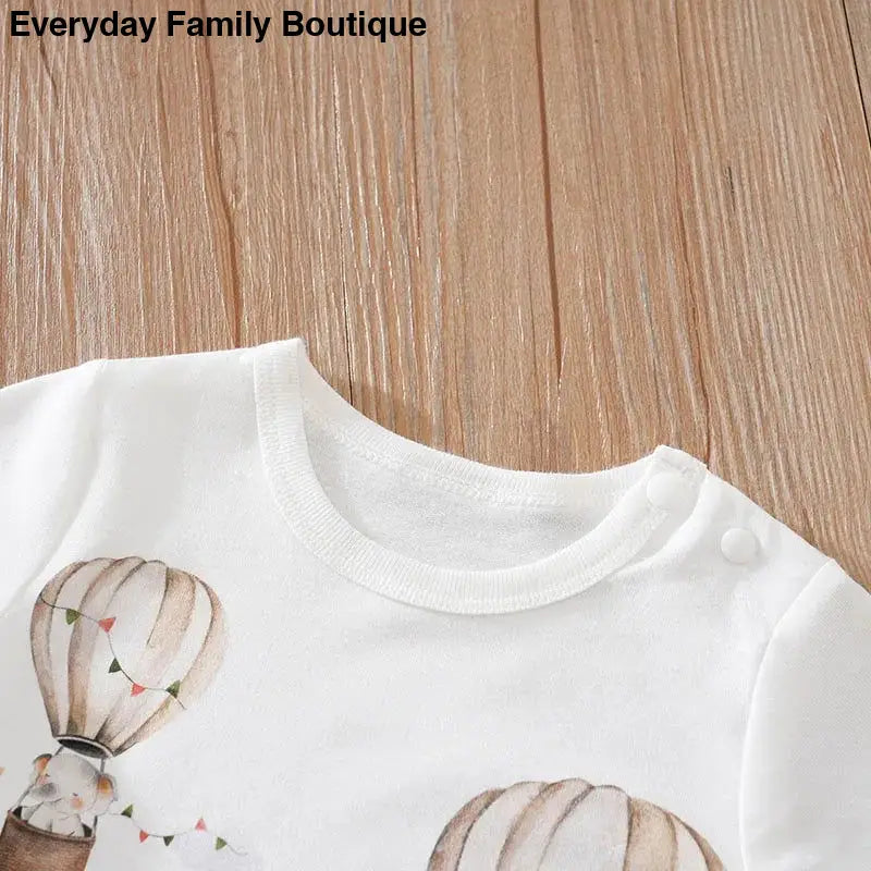 White t-shirt with hot air balloon design.