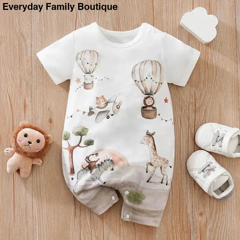 White baby romper with hot air balloons, animals, and whimsical woodland design.