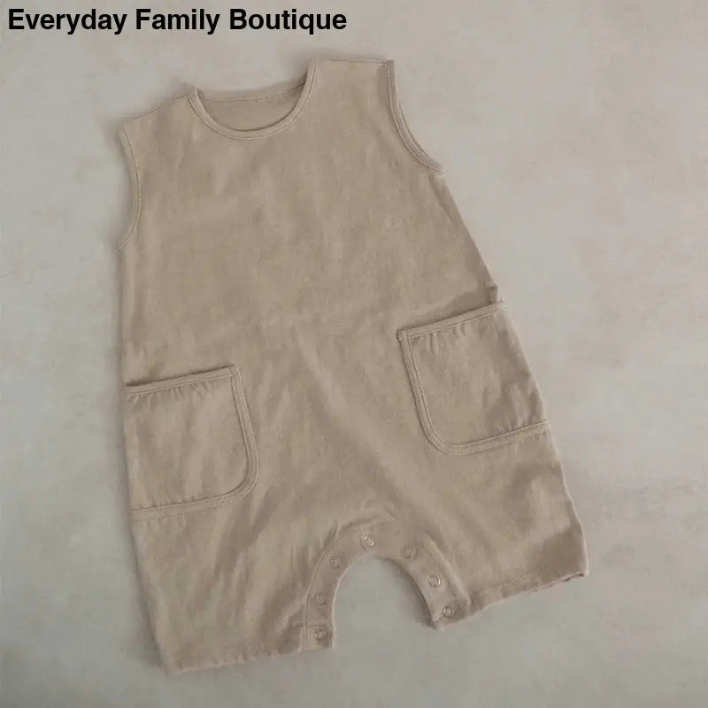 Beige sleeveless romper with two front patch pockets.