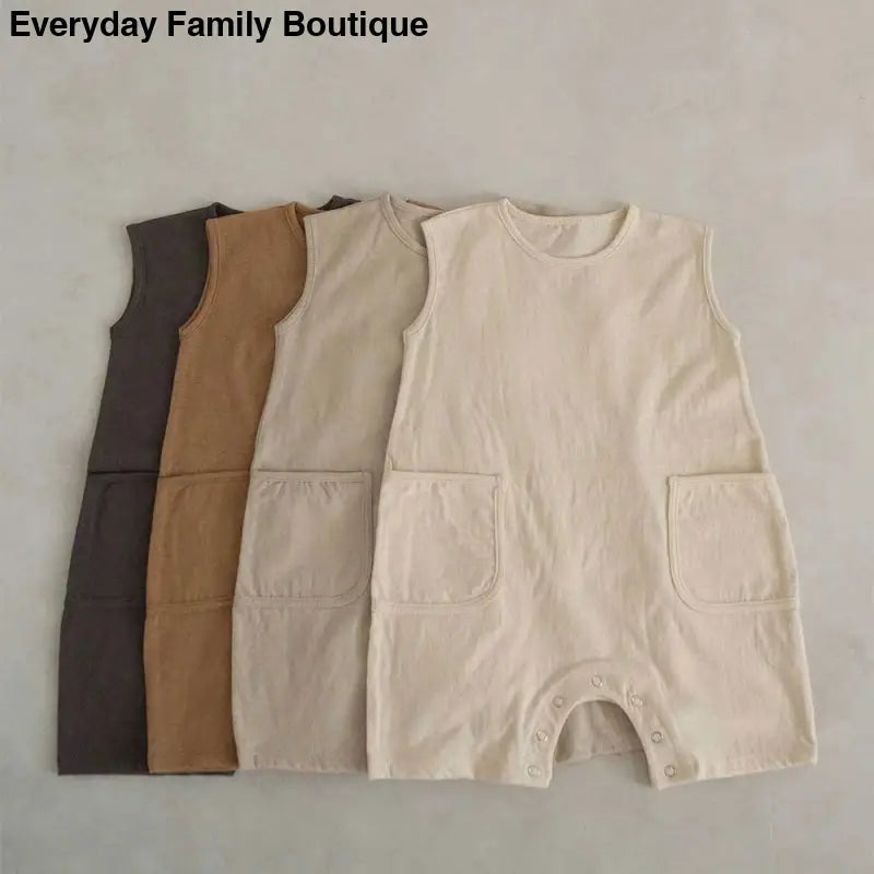 Sleeveless baby rompers in neutral earth-tone colors.