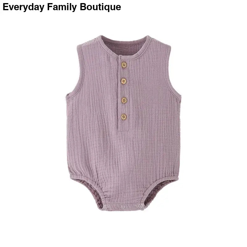 Dusty purple sleeveless baby romper with wooden buttons down the front.