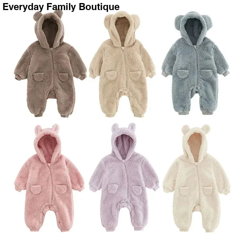 Plush baby onesies with animal ear hoods in different pastel colors.