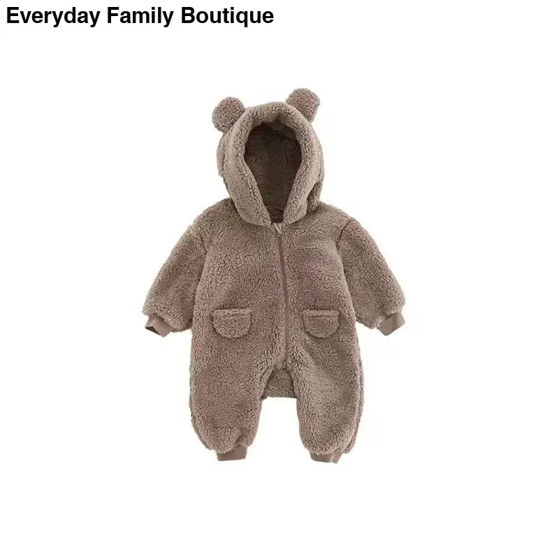 Plush brown teddy bear-style baby onesie with ears on the hood and front pockets.