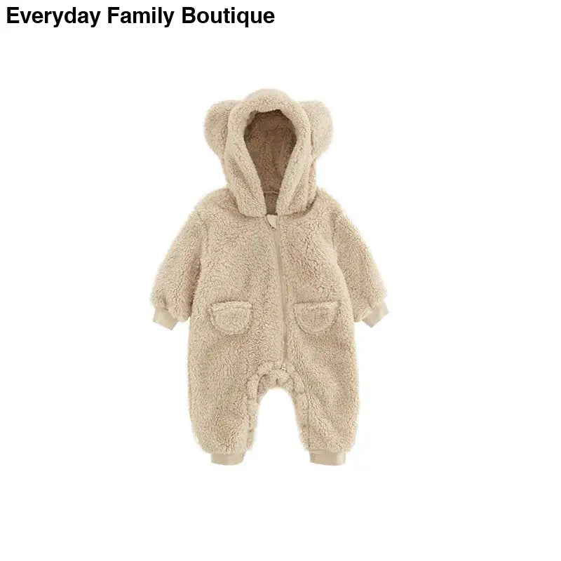 Beige teddy bear-style hooded baby snowsuit with front pockets.